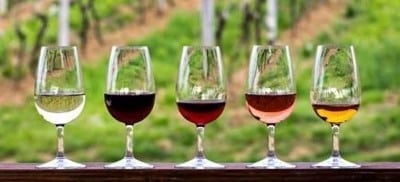 4 wine glass lined up with different wines